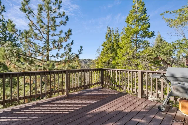 a view of balcony with wooden floor and fence
