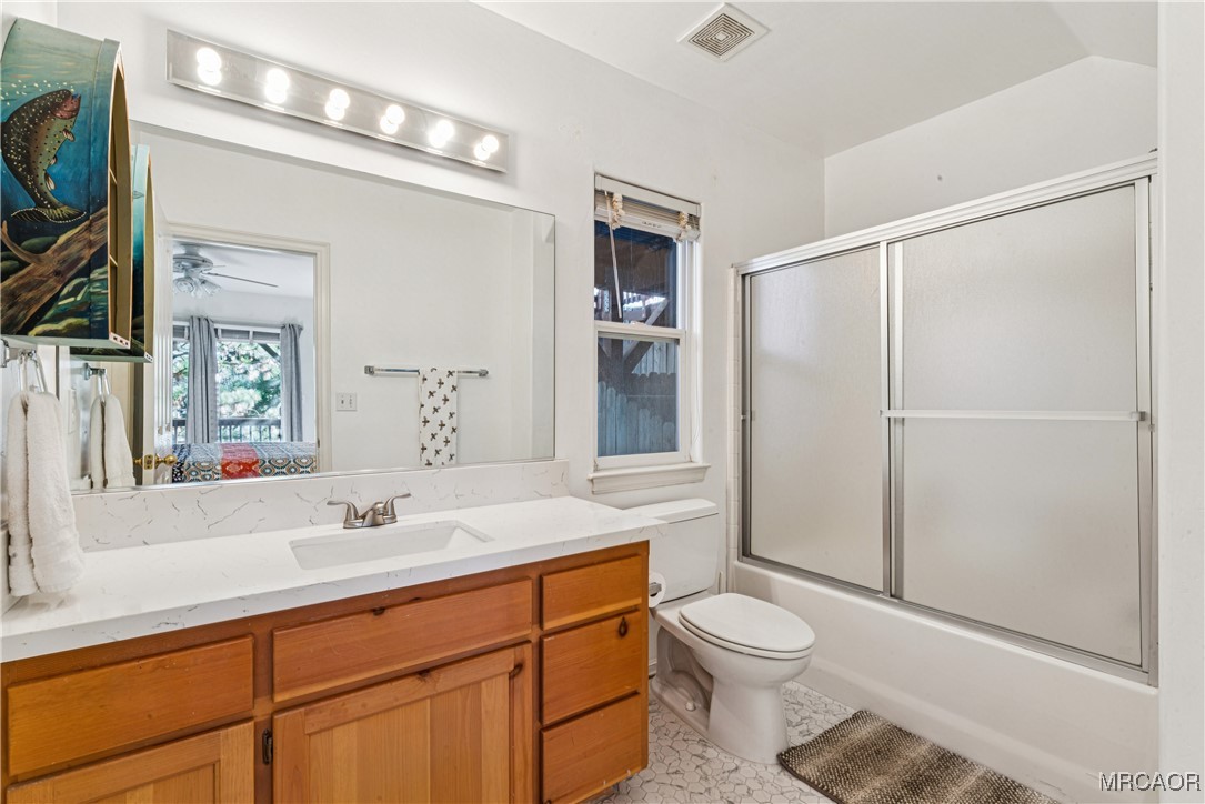 305 Summit Road Lake Arrowhead, CA 92352 - Photo 24 of 47 a bathroom with a sink toilet a mirror and shower