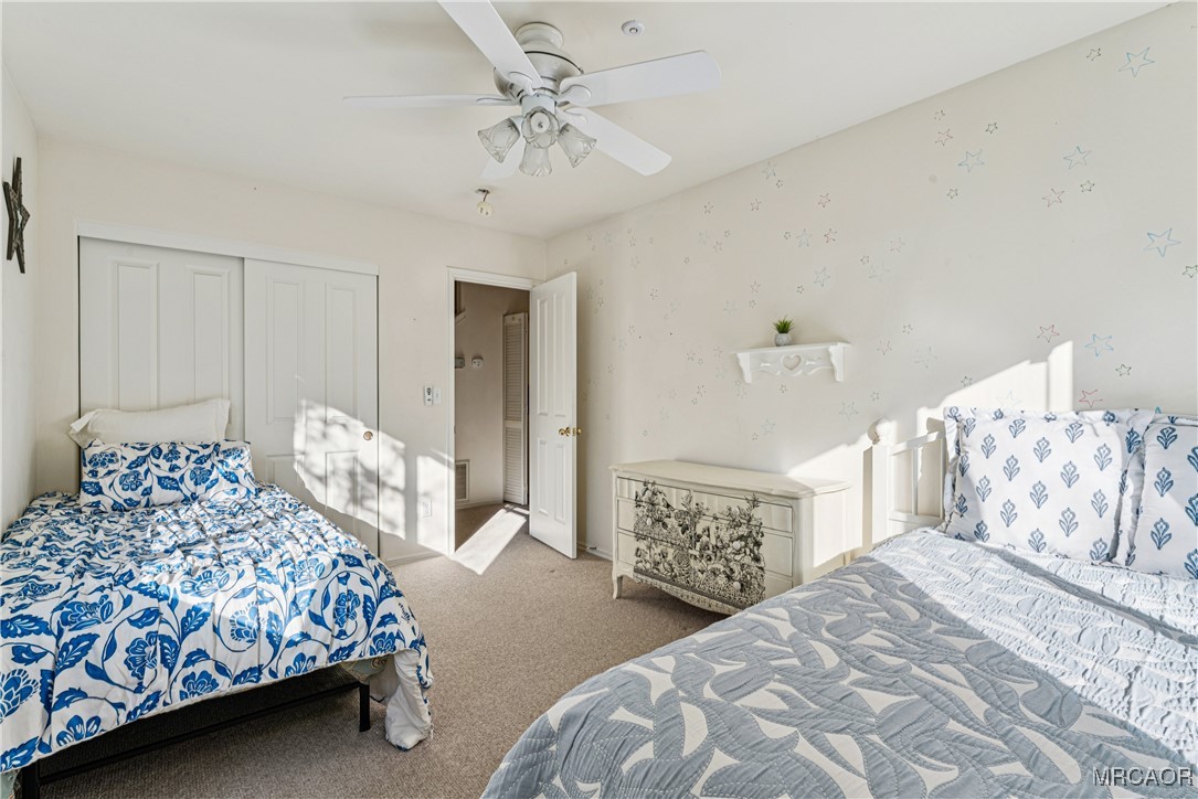 305 Summit Road Lake Arrowhead, CA 92352 - Photo 27 of 47 a bedroom with a large bed and a chandelier