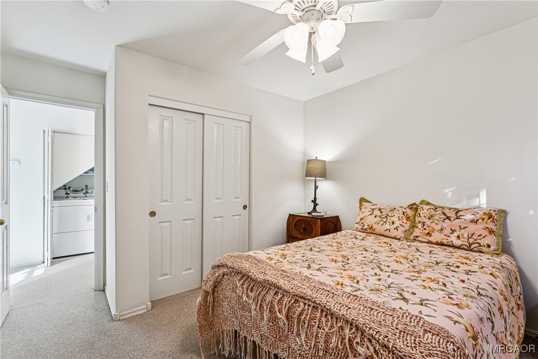 305 Summit Road Lake Arrowhead, CA 92352 - Photo 31 of 47 a bedroom with a large bed and a chandelier