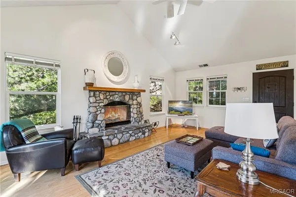 a living room with furniture fireplace and window