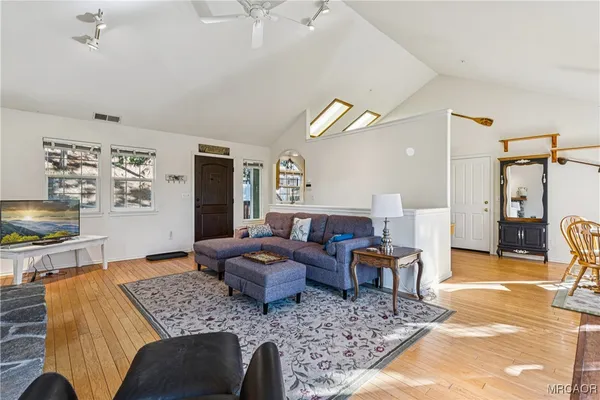 a living room with furniture and wooden floor
