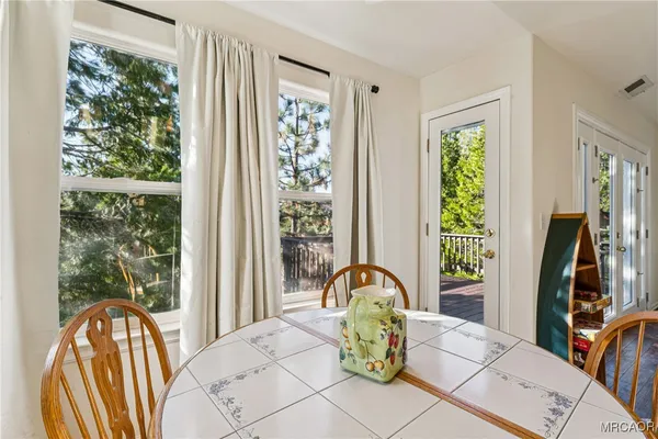 a living room with large window and furniture