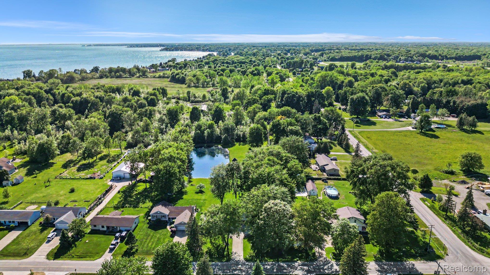 7020 Meldrum Road Fair Haven, MI 48023 - Photo 39 of 43 Expansive aerial perspective showcasing a significant body of water, lush green landscape, and residential properties