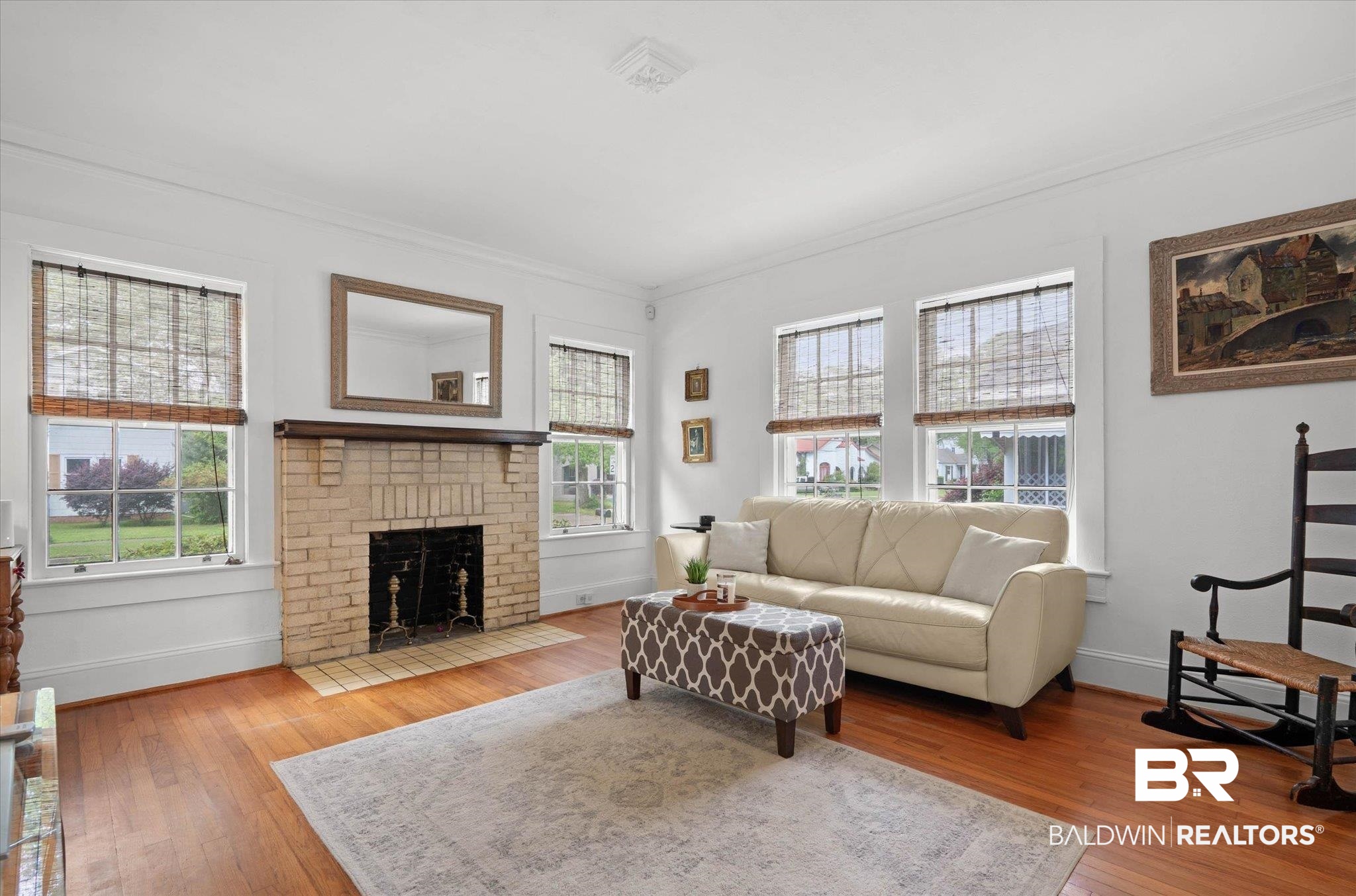 165 South Fulton Street Mobile, AL 36606 - Photo 4 of 24 Living room with light wood-style floors, a brick fireplace, and crown molding