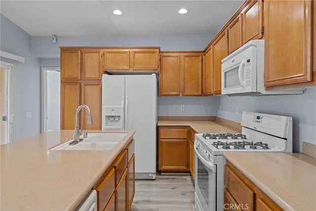 a kitchen with a sink a stove and cabinets