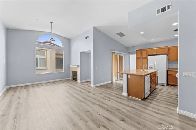 a view of a room with wooden floor and a window