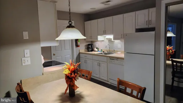 a kitchen with stainless steel appliances a sink and a refrigerator