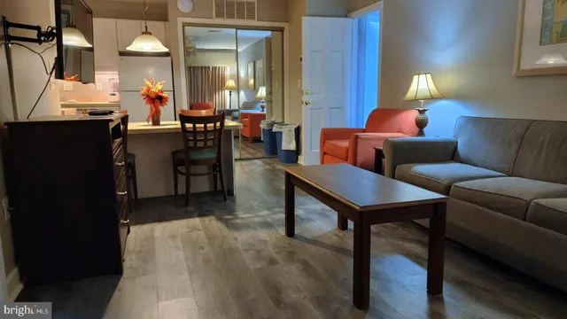 a living room with furniture a chandelier and a window