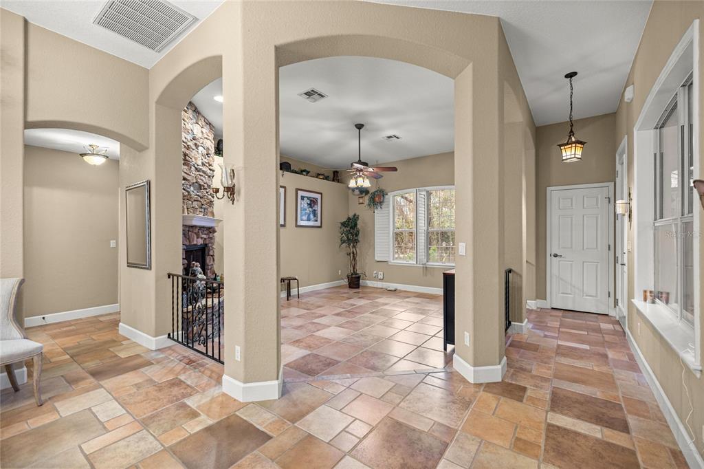 4280 Southeast 26th Terrace Road Ocala, FL 34480 - Photo 12 of 70 a view of a hallway with wooden floor and a living room
