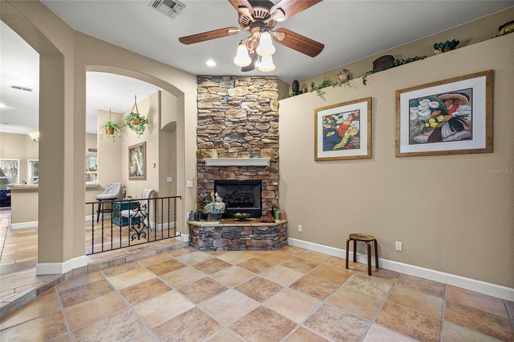 4280 Southeast 26th Terrace Road Ocala, FL 34480 - Photo 13 of 70 a living room with furniture a dining table and a fireplace
