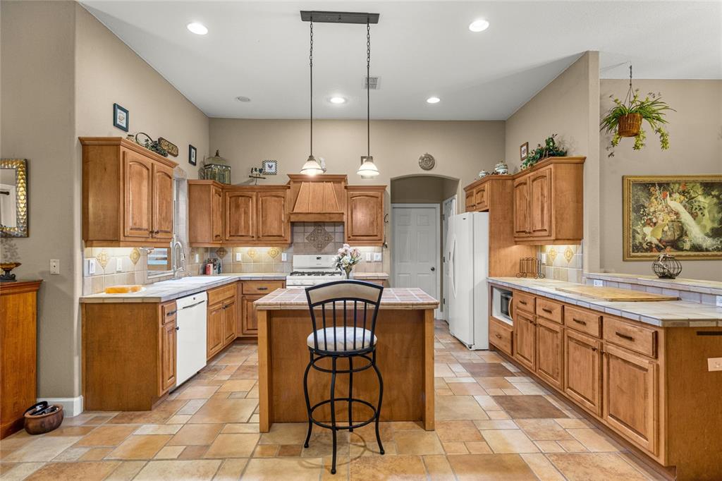 4280 Southeast 26th Terrace Road Ocala, FL 34480 - Photo 21 of 70 a kitchen with stainless steel appliances kitchen island granite countertop a sink and cabinets