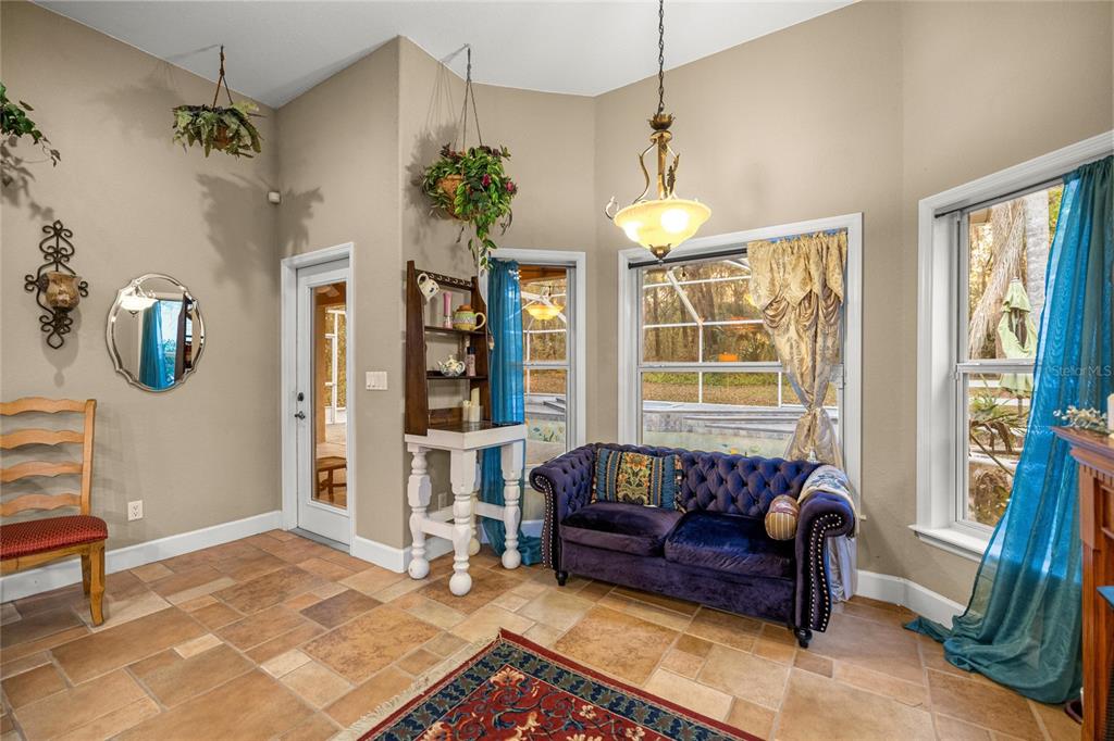 4280 Southeast 26th Terrace Road Ocala, FL 34480 - Photo 23 of 70 a living room with furniture and a chandelier