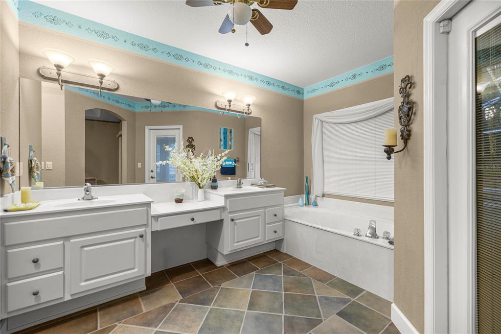 4280 Southeast 26th Terrace Road Ocala, FL 34480 - Photo 27 of 70 a bathroom with a double vanity sink mirror and toilet