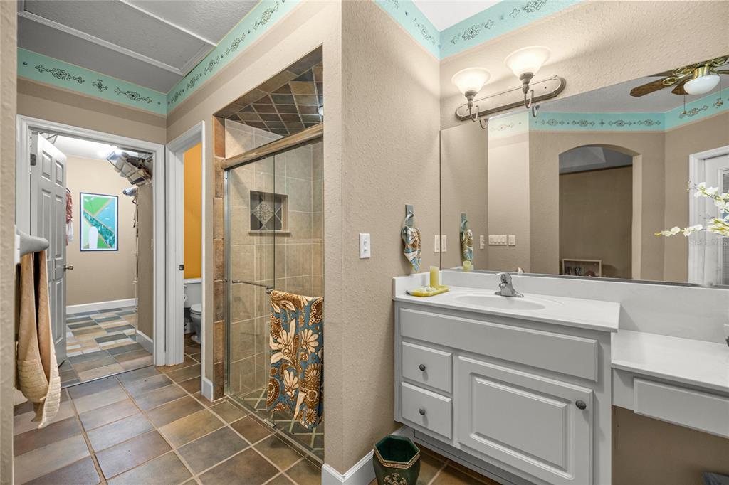 4280 Southeast 26th Terrace Road Ocala, FL 34480 - Photo 29 of 70 a bathroom with a double vanity sink mirror and shower