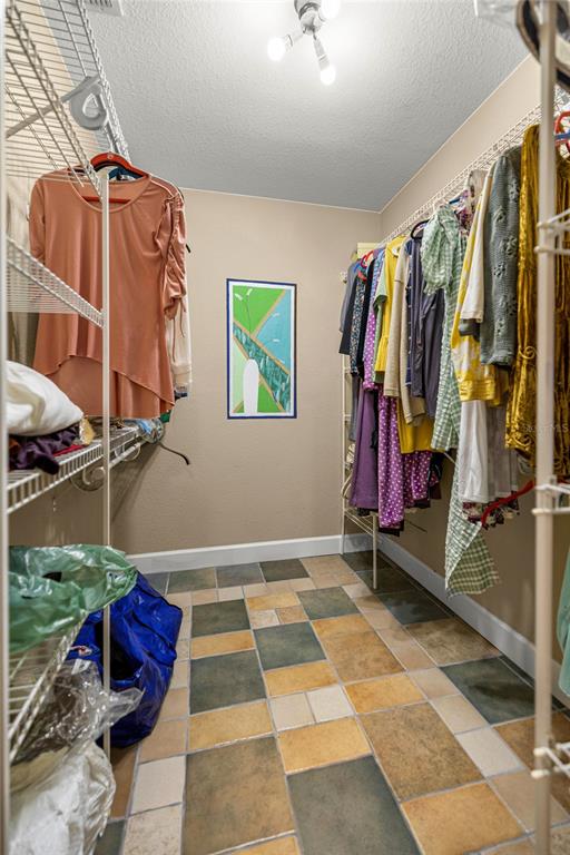 4280 Southeast 26th Terrace Road Ocala, FL 34480 - Photo 31 of 70 a view of walk in closet with clothes and shoes