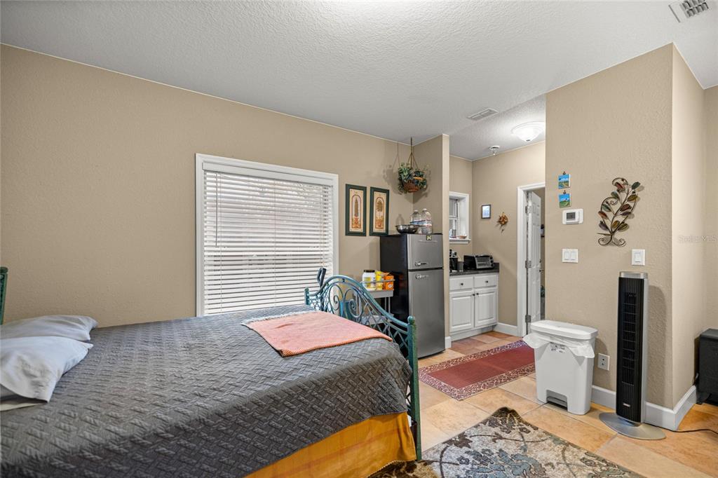 4280 Southeast 26th Terrace Road Ocala, FL 34480 - Photo 38 of 70 a bedroom with a bed and a dresser in it