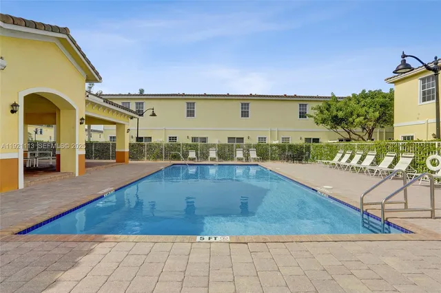 a kitchen with stainless steel appliances a refrigerator and a stove top oven