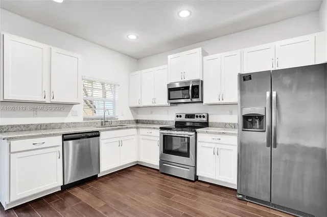 a view of empty room with white walls