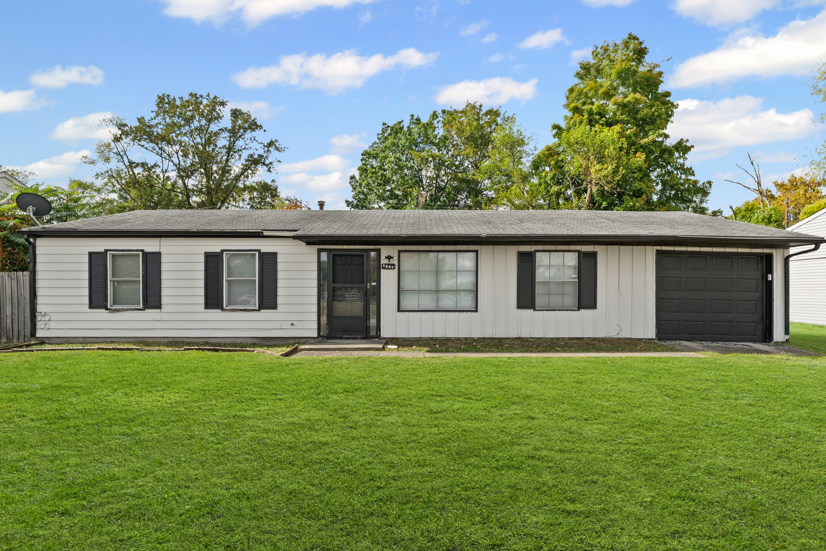 a house that has a big yard with wooden fence
