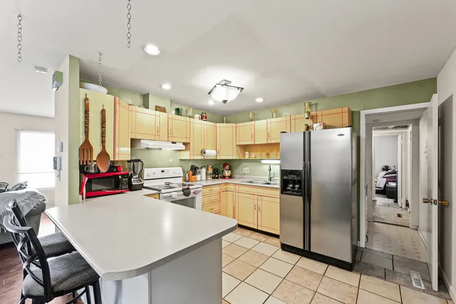 a kitchen with refrigerator and cabinets