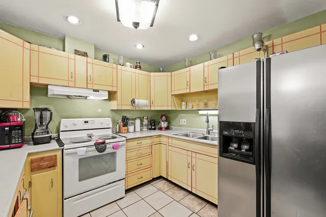 a kitchen with cabinets and appliances
