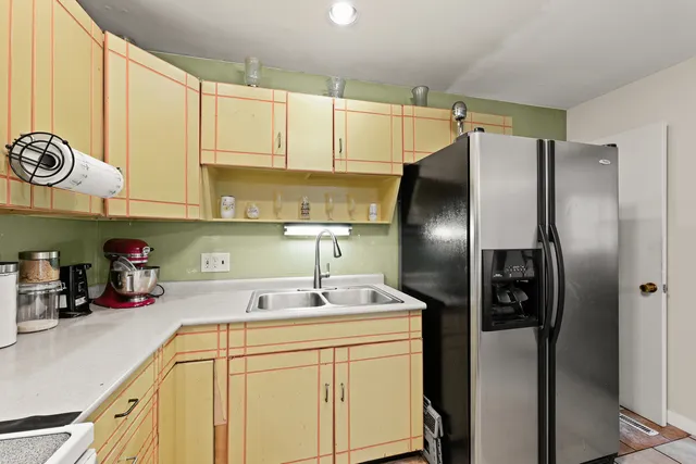 a kitchen with a sink and a refrigerator