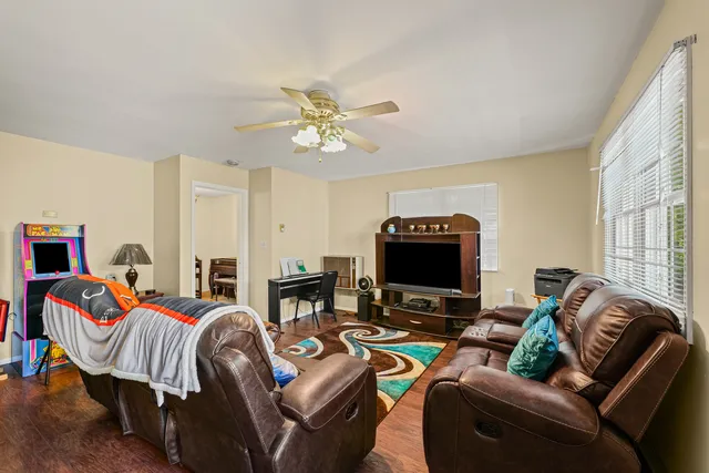 a bedroom with furniture and a flat screen tv