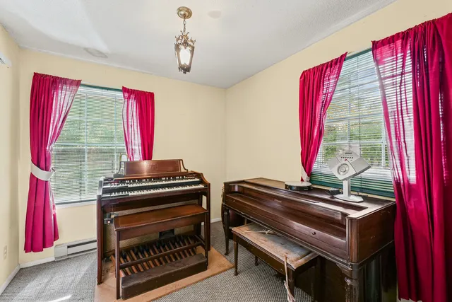 a view of a room with furniture and windows
