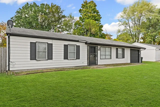a view of a house with a backyard