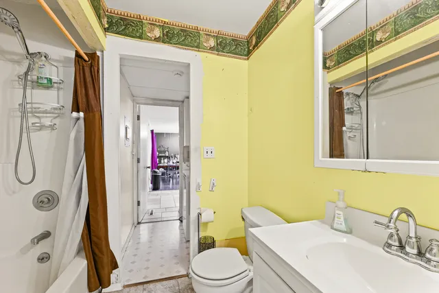 a bathroom with a sink toilet and shower