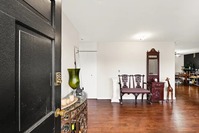 a view of a livingroom with furniture wooden floor and front door