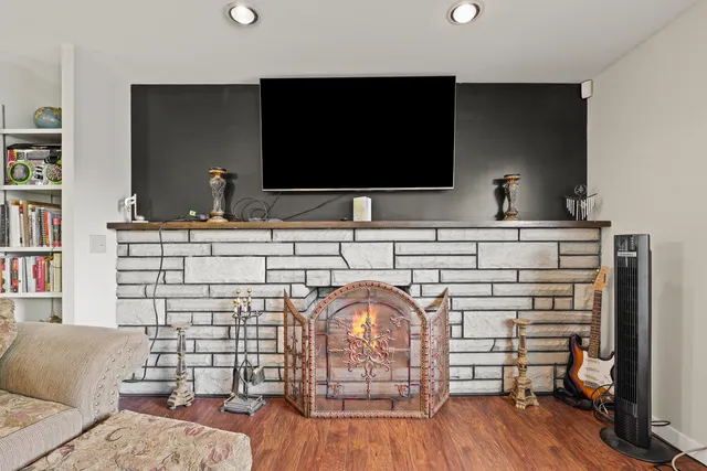 a living room with a bed and flat screen tv
