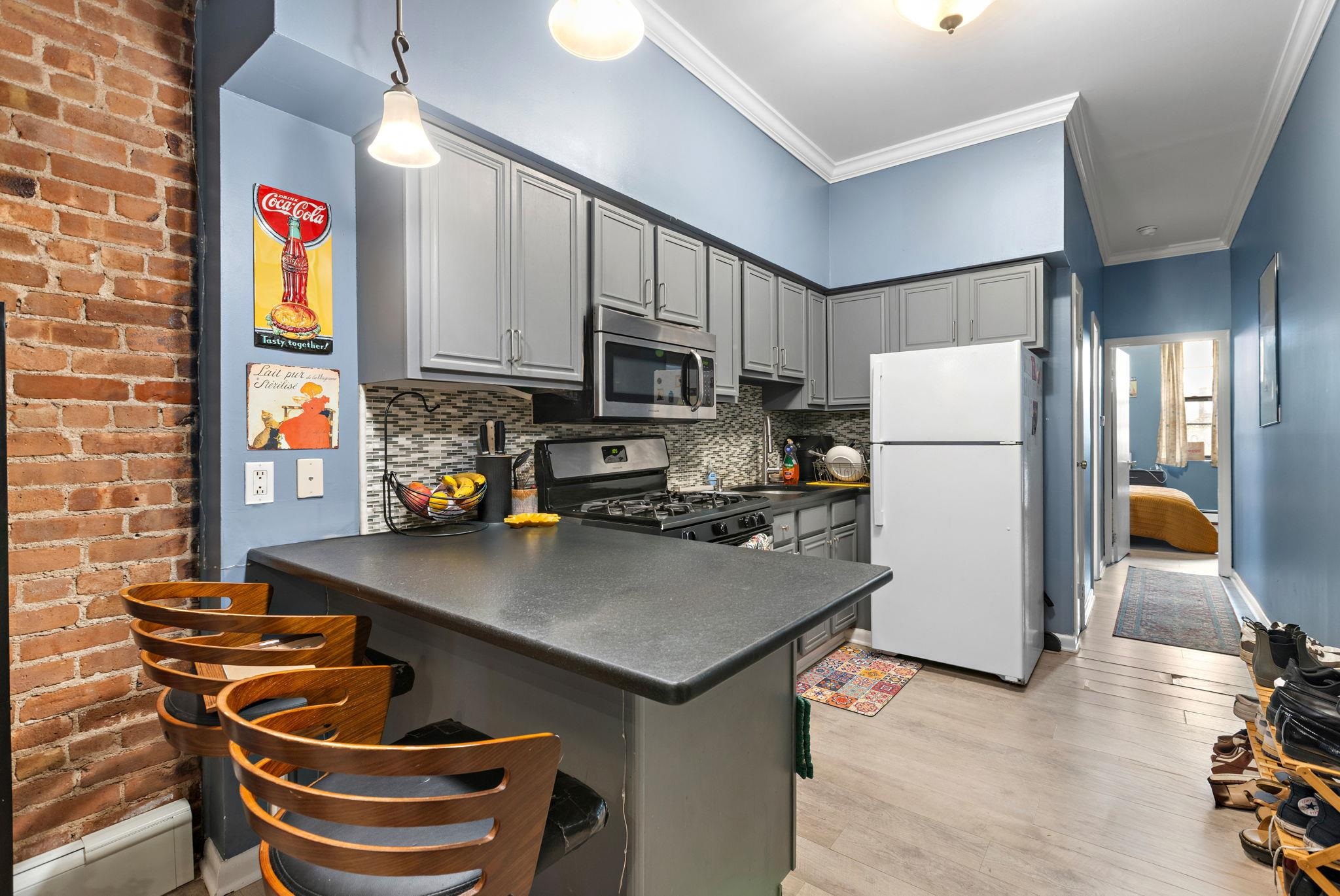 263 1st Street, Unit 2R Hoboken, NJ 07030 - Photo 5 of 13 a kitchen with a refrigerator and a stove top oven