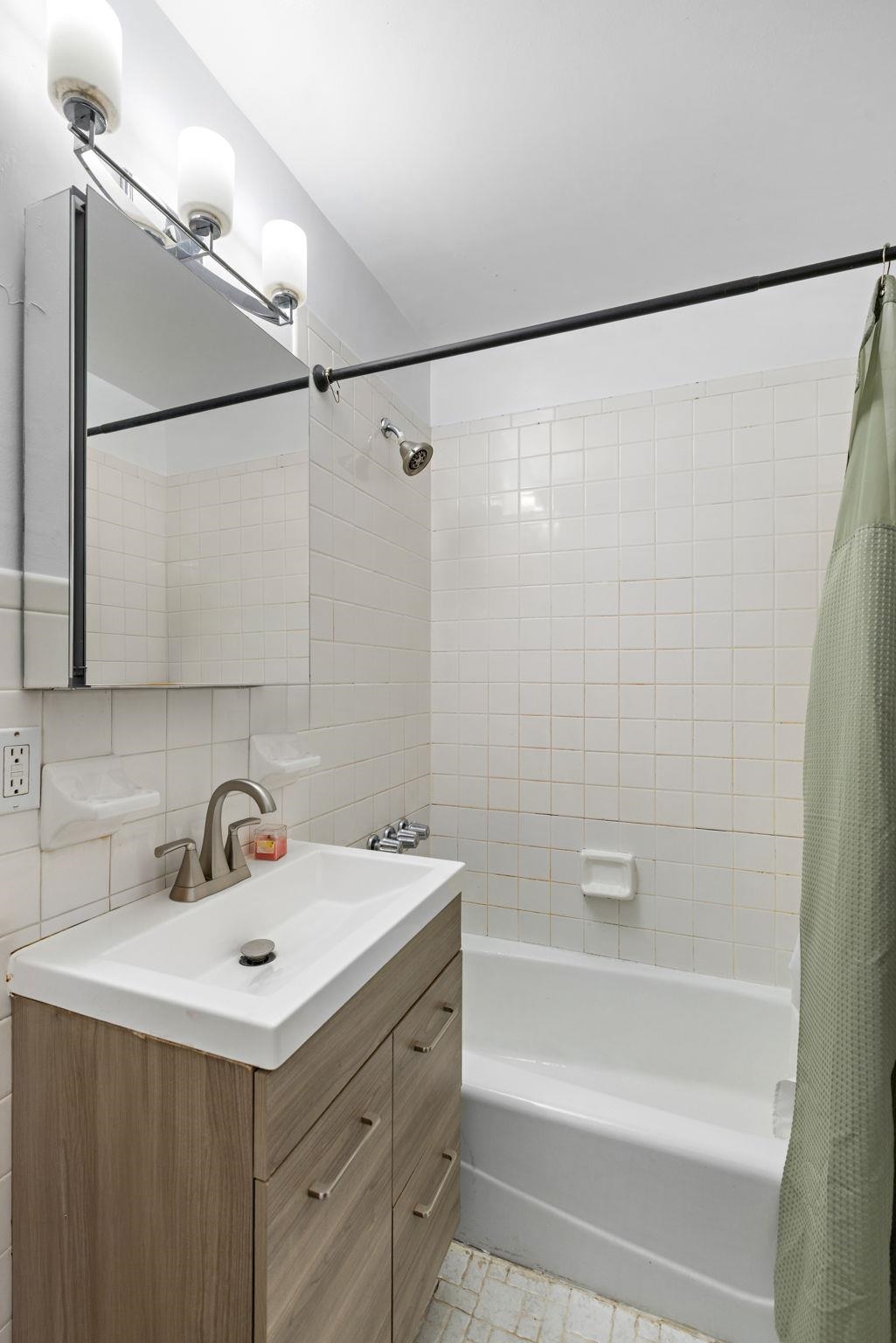 263 1st Street, Unit 2R Hoboken, NJ 07030 - Photo 8 of 13 a bathroom with a sink and a bathtub