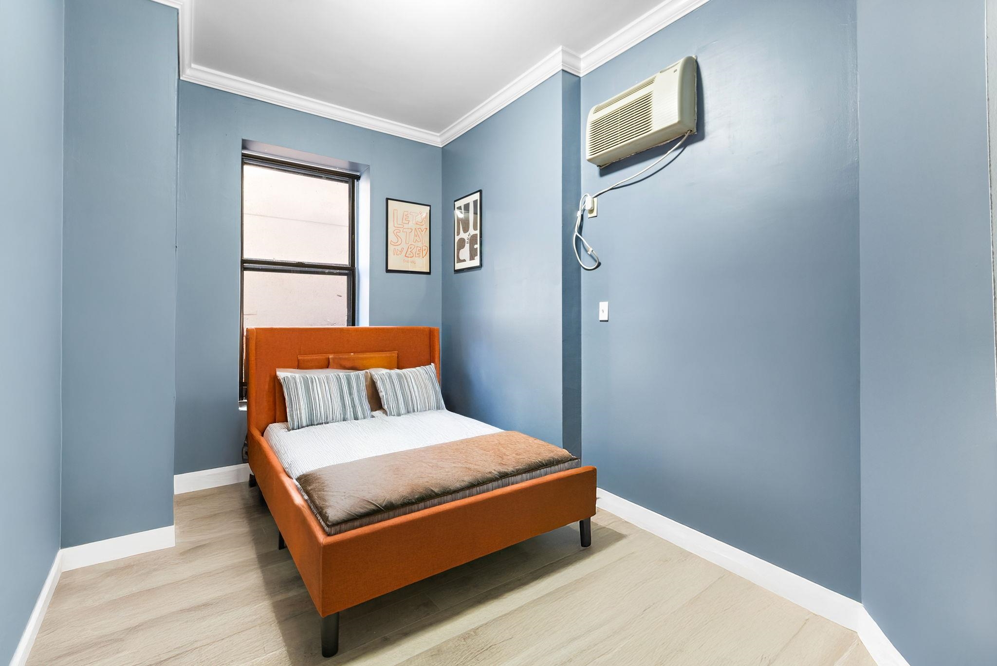 263 1st Street, Unit 2R Hoboken, NJ 07030 - Photo 9 of 13 a bedroom with a bed lamp and a window