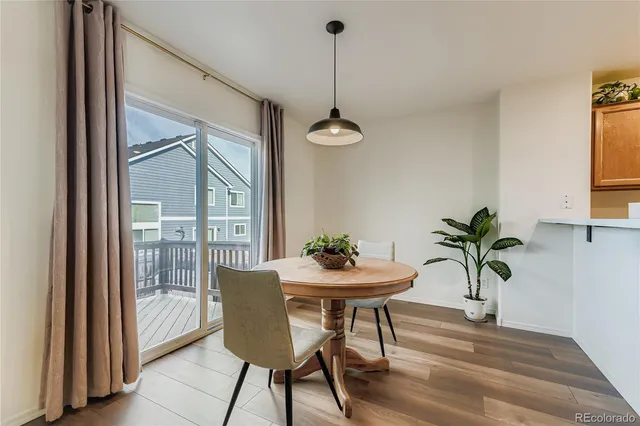 a view of a dining room with furniture window and wooden floor