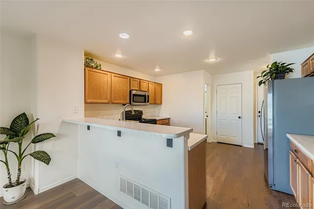 a view of a kitchen with microwave and refrigerator