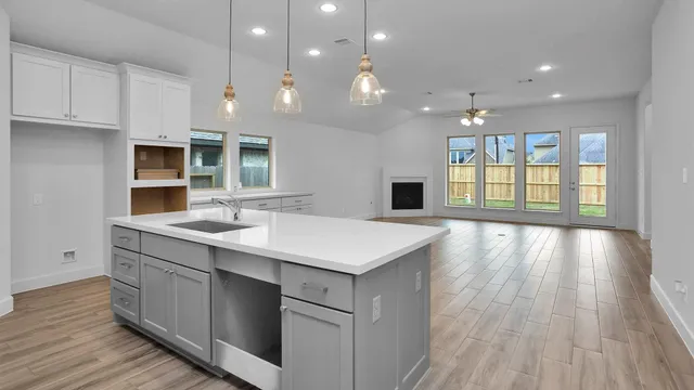 a kitchen with a wooden floor and window