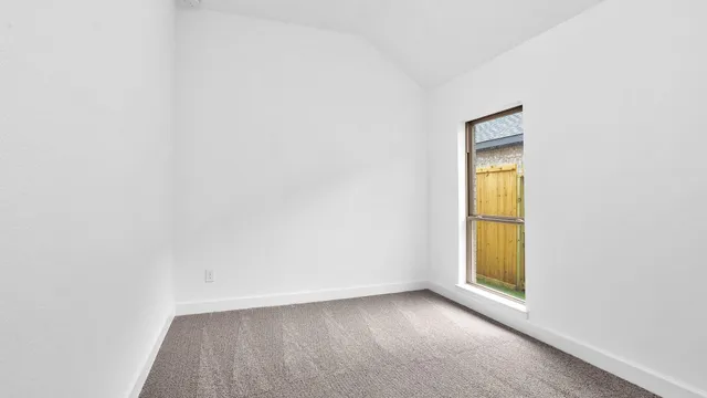 a view of an empty room and a window