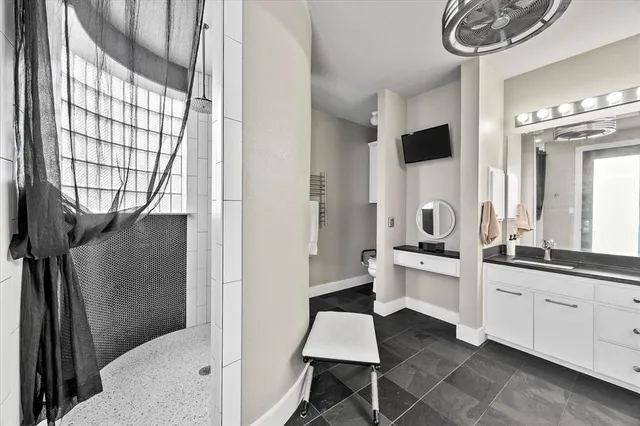 a bathroom with a sink toilet and shower