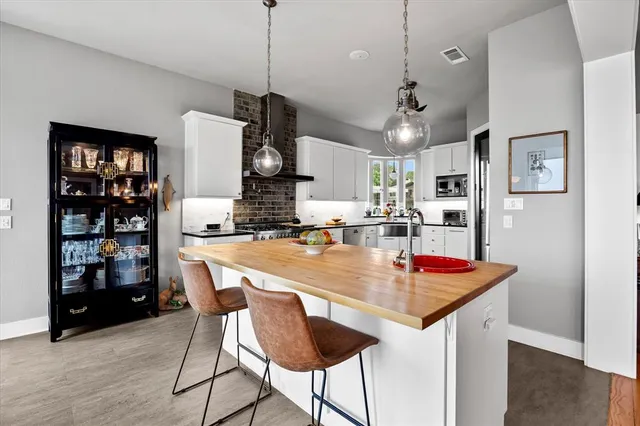 a kitchen with stainless steel appliances a refrigerator sink and cabinets