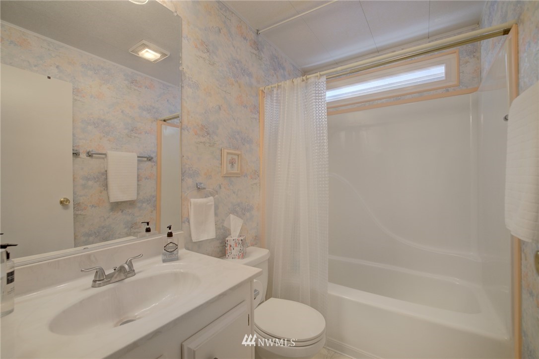 1121 244th Street Southwest, Unit 18 Bothell, WA 98021 - Photo 22 of 37 a bathroom with a bathtub shower sink vanity and toilet
