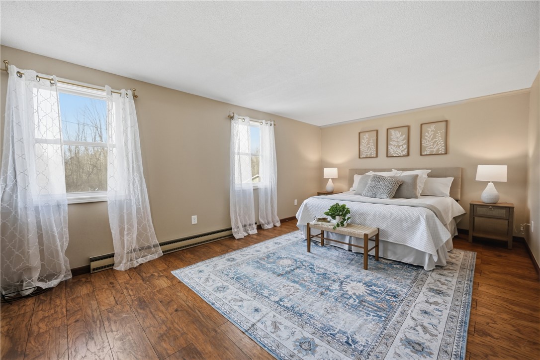 1437 Hosmer Road Somerset, NY 14012 - Photo 11 of 42 primary bedroom with half bath and walk-in closet