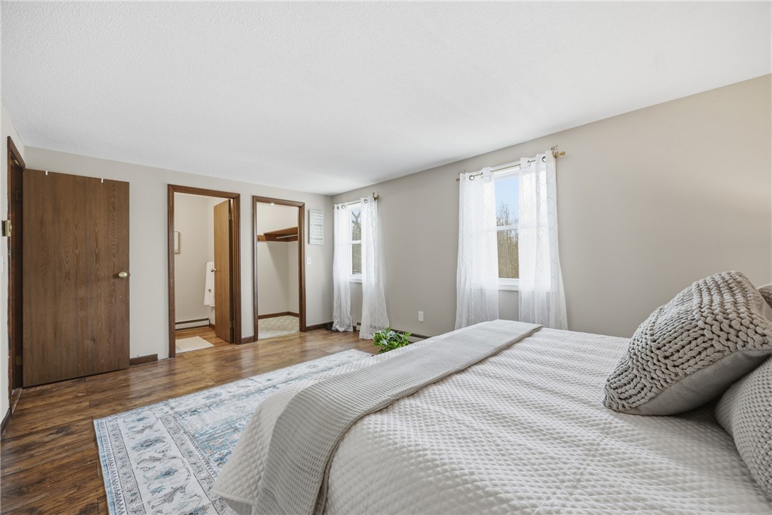 1437 Hosmer Road Somerset, NY 14012 - Photo 12 of 42 primary bedroom with half bath and walk-in closet