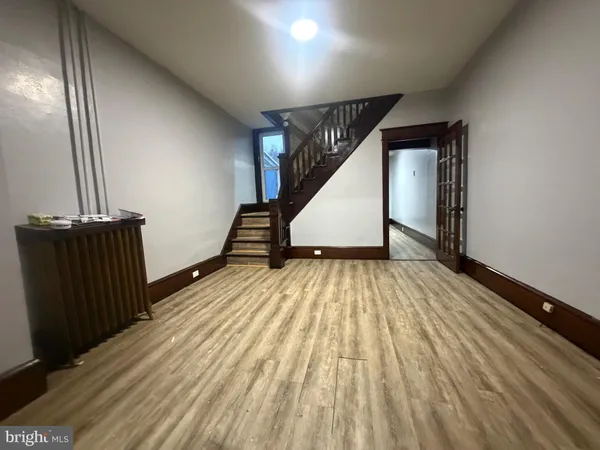 a view of a room with wooden floor and windows