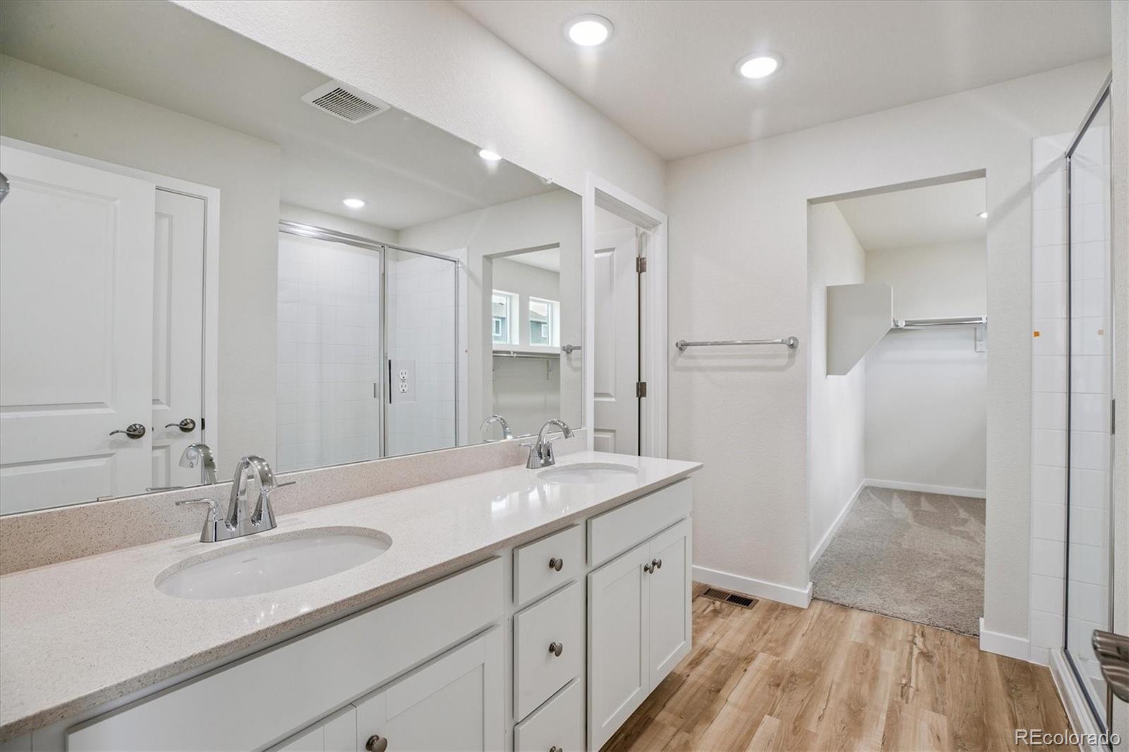 42591 Kinloch Trail Elizabeth, CO 80107 - Photo 14 of 21 a en suite bathroom with double vanity and a mirror