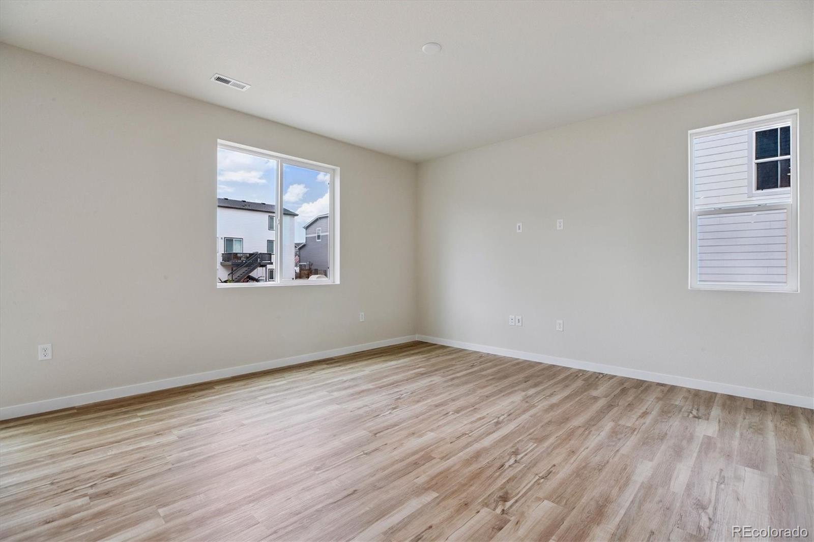 42591 Kinloch Trail Elizabeth, CO 80107 - Photo 9 of 21 a view of an empty room with wooden floor and a window