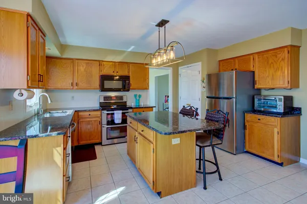a kitchen that has cabinets a sink and appliances
