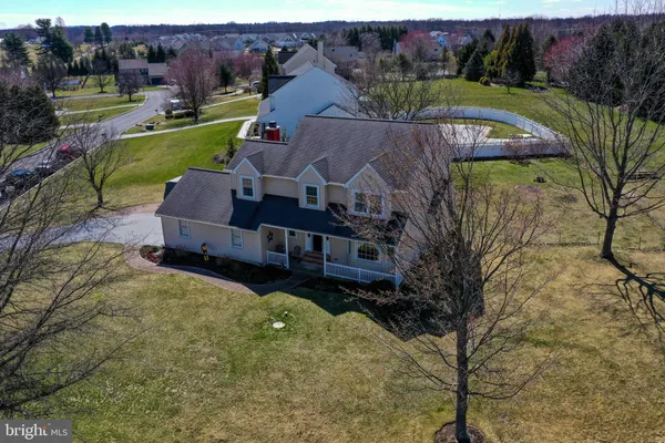 an aerial view of a house with garden space and lake view